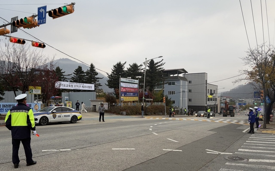 ▲ 경찰, 모범 운전자 등이 수능시험장인 가평중학교 교차로를 정리하고 있다.