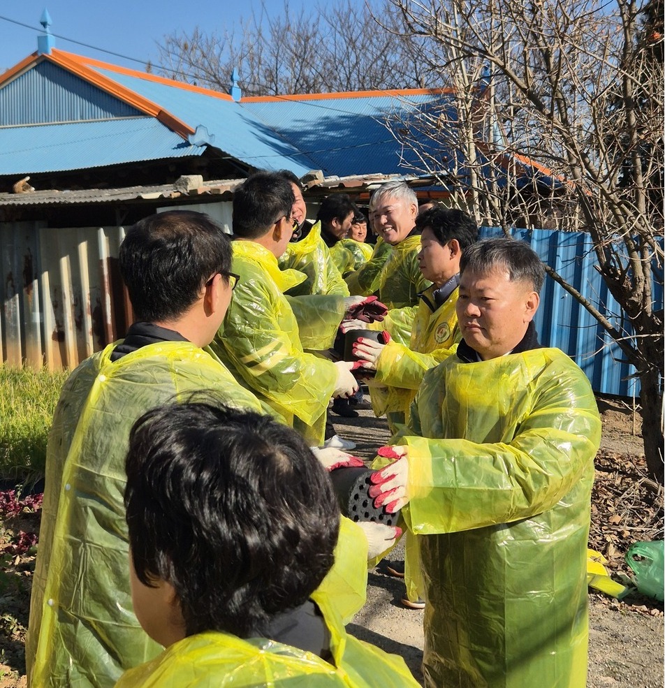 ▲ 평택시기자단과 자원봉사자들이 연탄을 나르고 있는 모습. /사진제공=평택시기자단