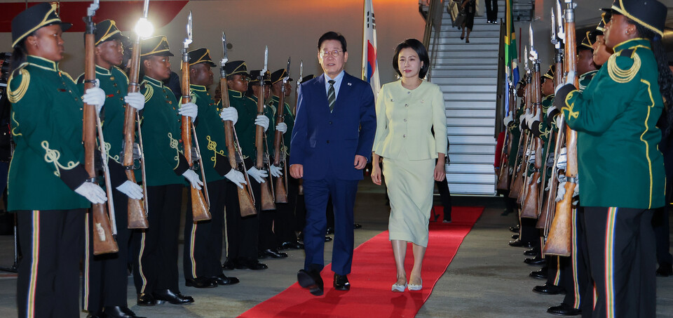 ▲ 주요 20개국(G20) 정상회의에 참석하는 이재명 대통령이 김혜경 여사와 함께 21일(현지시간) 남아프리카공화국 요하네스버그 OR탐보국제공항에 도착한 뒤 공군 1호기에서 내려 이동하고 있다. /연합뉴스